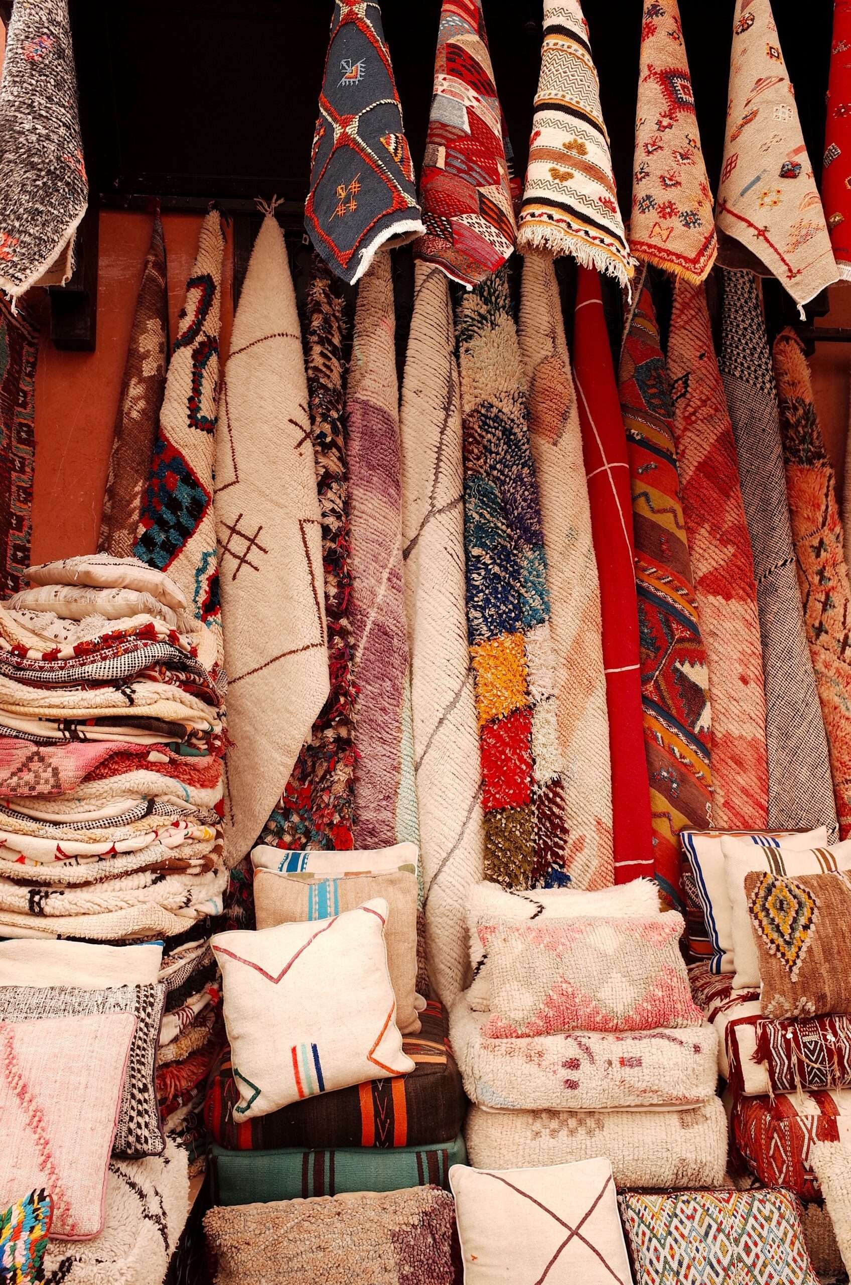 Handmade Moroccan Rugs hanged on the wall together with handmade Moroccan Pillows