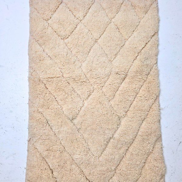 Minimalistic Moroccan Azilal rug with bold geometric patterns in white wool, featuring abstract Berber tribal motifs and handwoven texture.