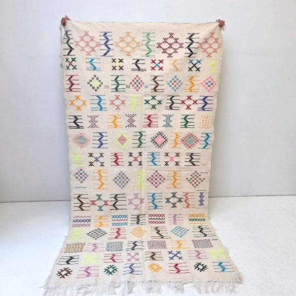 Colorful Moroccan Azilal rug with bold geometric patterns in red, orange, purple, and multicolor wool, featuring abstract Berber tribal motifs and handwoven texture.