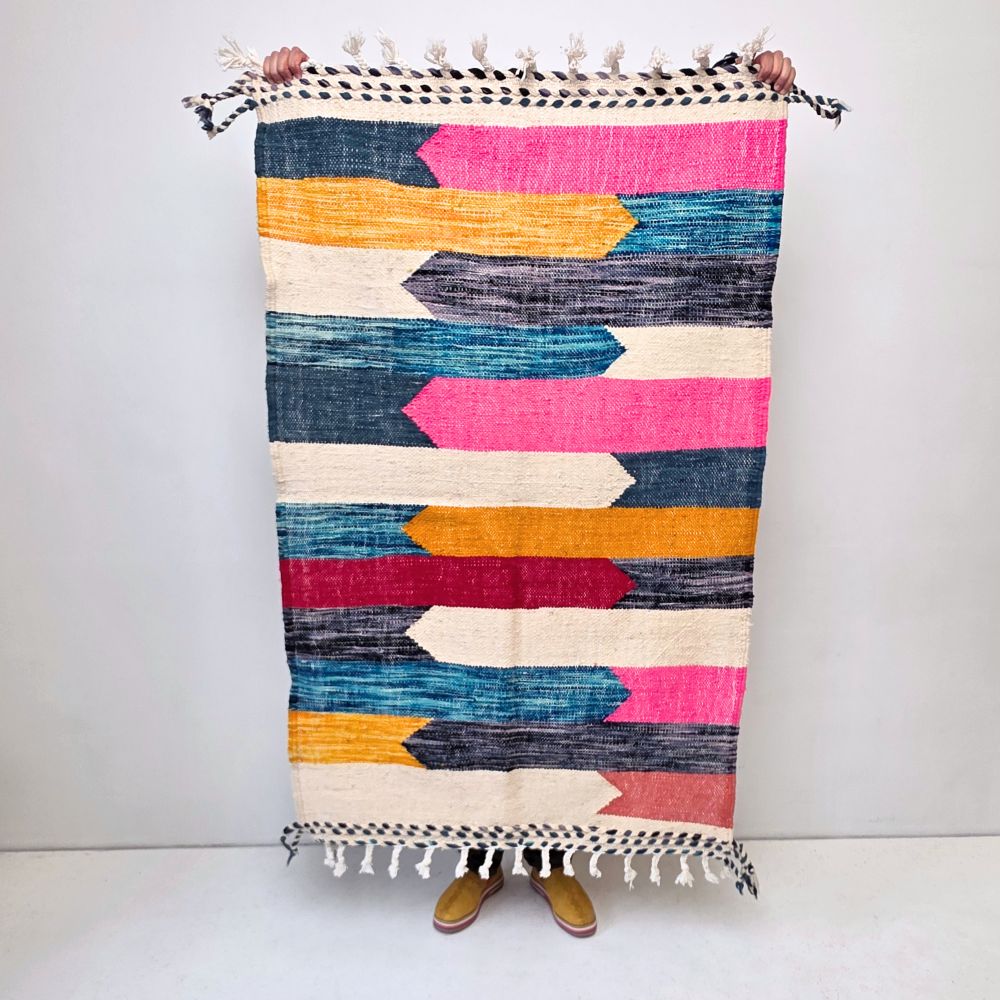 Minimalistic Moroccan Azilal rug with bold geometric patterns in white, brown, blue and multicolor wool, featuring abstract Berber tribal motifs and handwoven texture.