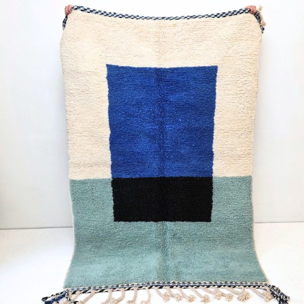 Colorful Moroccan Beni Ourain rug with blue, black and mint geometric patterns featuring abstract Berber tribal motifs and handwoven texture.