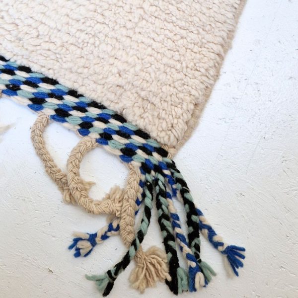 Colorful Moroccan Beni Ourain rug with blue, black and mint geometric patterns featuring abstract Berber tribal motifs and handwoven texture.