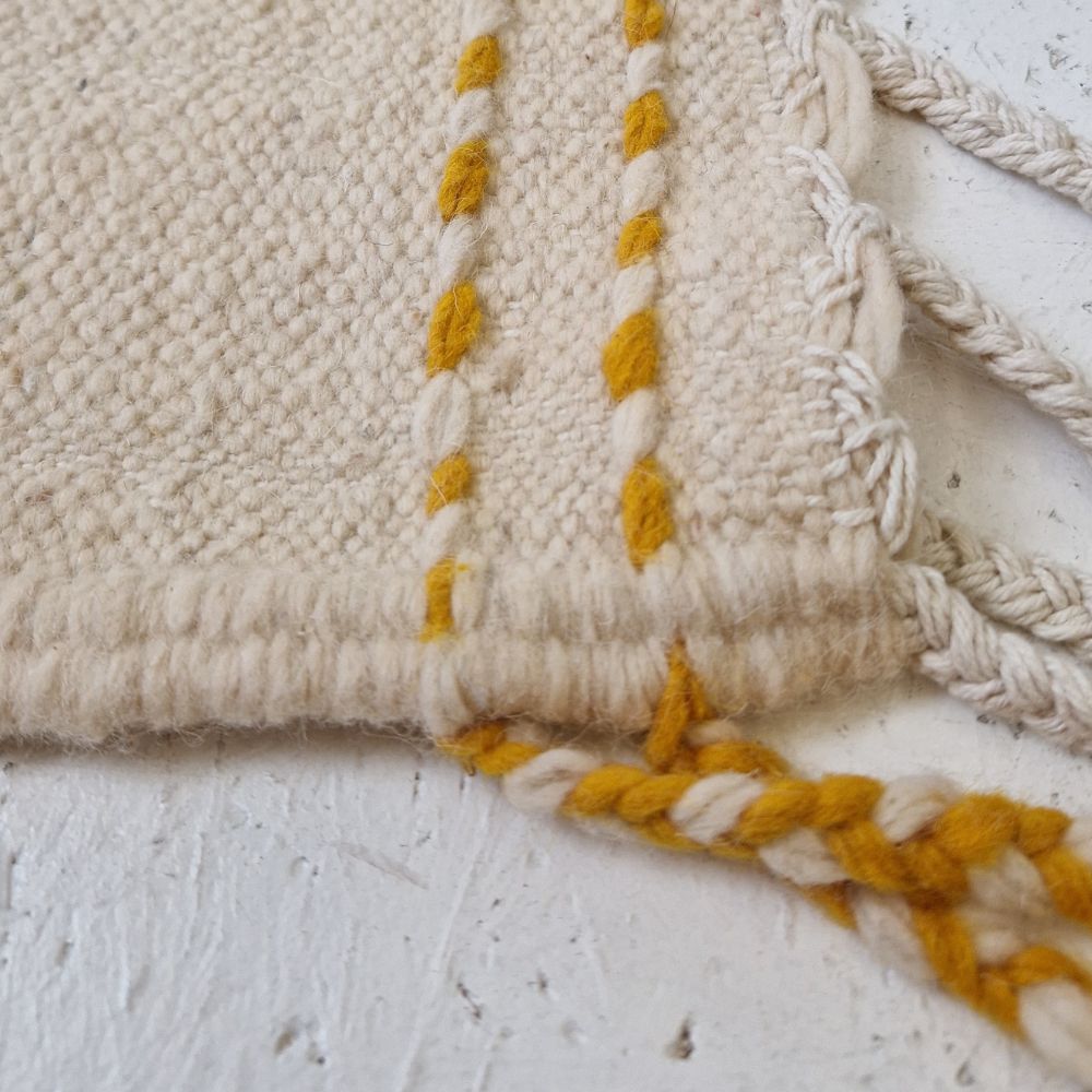 Colorful Moroccan rug with bold geometric patterns in orange, brown, purple, blue and multicolor wool, featuring abstract Berber tribal motifs and handwoven texture.