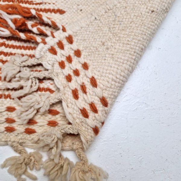 Minimalistic Moroccan Azilal rug with bold geometric patterns in white and brown wool, featuring abstract Berber tribal motifs and handwoven texture.