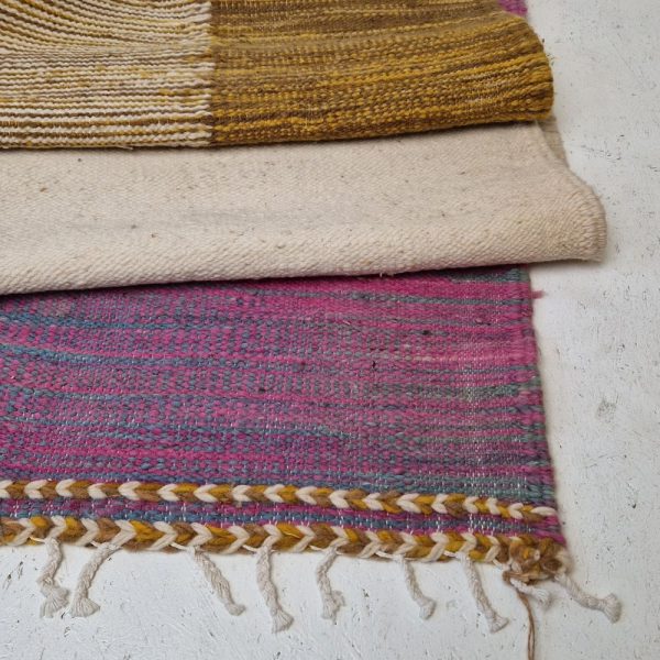 Colorful Moroccan rug with bold geometric patterns in orange, brown, pirple and multicolor wool, featuring abstract Berber tribal motifs and handwoven texture.