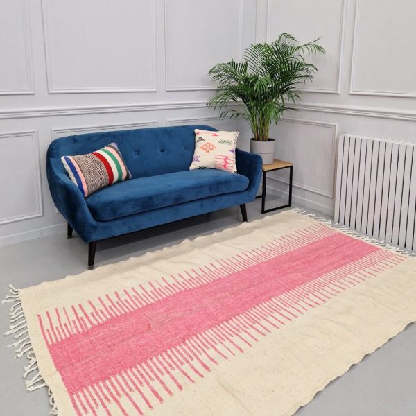 Minimalistic Moroccan Azilal rug with bold geometric patterns in white and pink wool, featuring abstract Berber tribal motifs and handwoven texture.