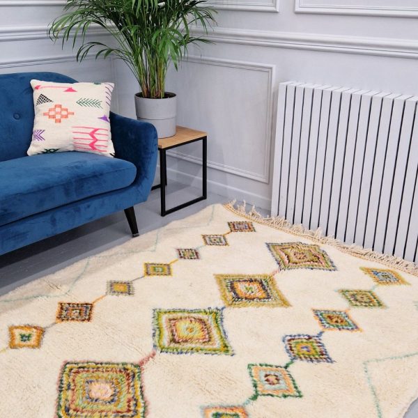 Colorful Moroccan Beni Ourain rug with blue, brown, red, black geometric patterns featuring abstract Berber tribal motifs and handwoven texture.