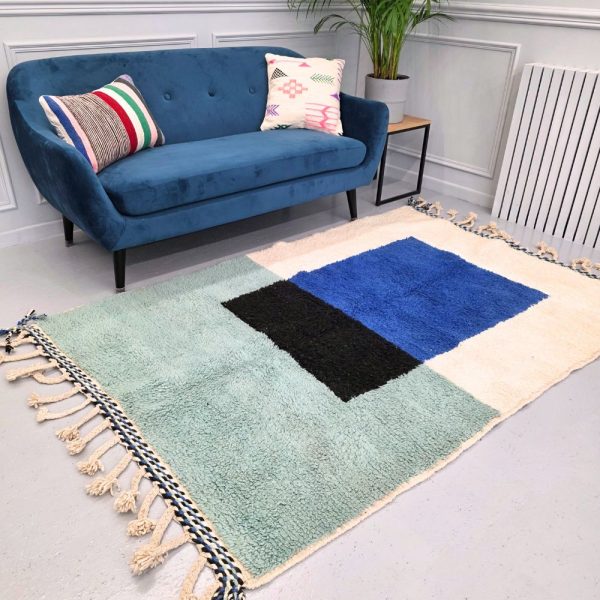 Colorful Moroccan Beni Ourain rug with blue, black and mint geometric patterns featuring abstract Berber tribal motifs and handwoven texture.