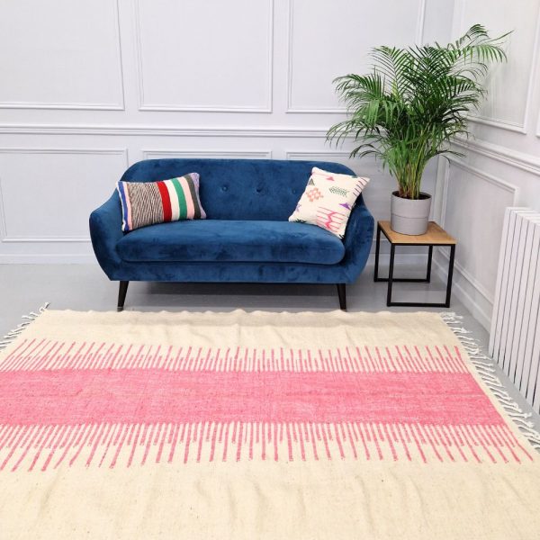 Minimalistic Moroccan Azilal rug with bold geometric patterns in white and pink wool, featuring abstract Berber tribal motifs and handwoven texture.