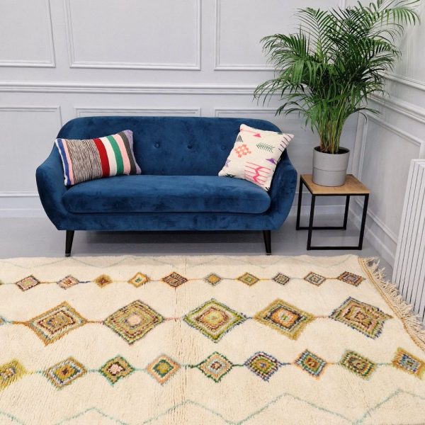 Colorful Moroccan Beni Ourain rug with blue, brown, red, black geometric patterns featuring abstract Berber tribal motifs and handwoven texture.