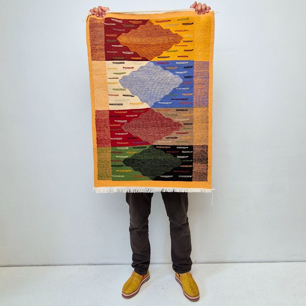 Bohemian Moroccan Azilal rug with bold geometric patterns in red, orange, purple, and multicolor wool, featuring abstract Berber tribal motifs and handwoven texture.