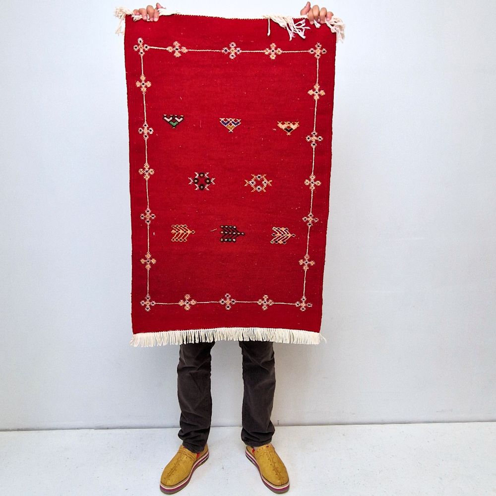 Bohemian Moroccan Azilal rug with bold geometric patterns in red, orange, purple, and multicolor wool, featuring abstract Berber tribal motifs and handwoven texture.