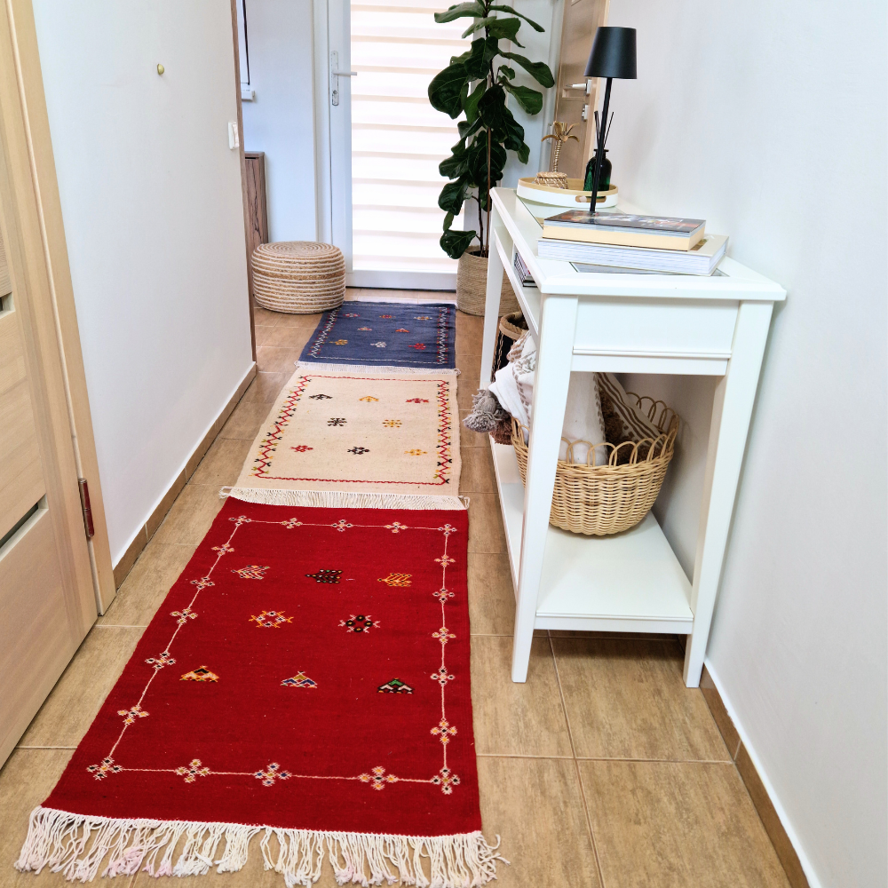 Bohemian Moroccan Azilal rug with bold geometric patterns in red, blue, white and multicolor wool, featuring abstract Berber tribal motifs and handwoven texture.