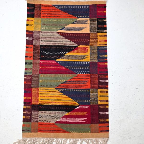 Bohemian Moroccan Azilal rug with bold geometric patterns in red, orange, purple, and multicolor wool, featuring abstract Berber tribal motifs and handwoven texture.