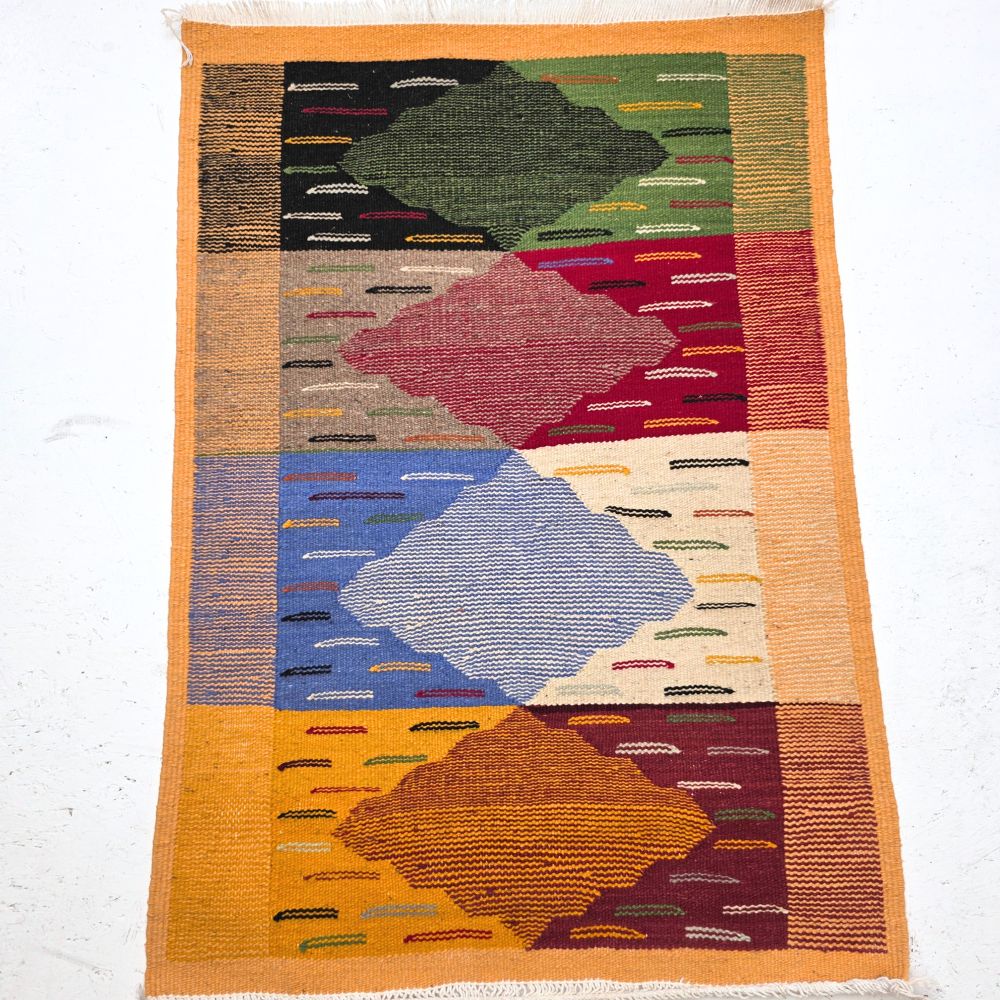 Bohemian Moroccan Azilal rug with bold geometric patterns in red, orange, purple, and multicolor wool, featuring abstract Berber tribal motifs and handwoven texture.