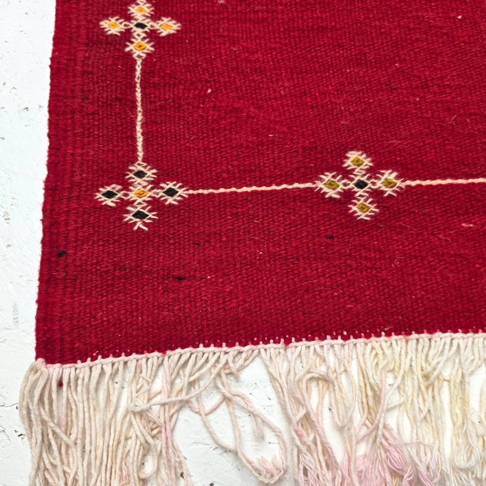 Bohemian Moroccan Azilal rug with bold geometric patterns in red, orange, purple, and multicolor wool, featuring abstract Berber tribal motifs and handwoven texture.