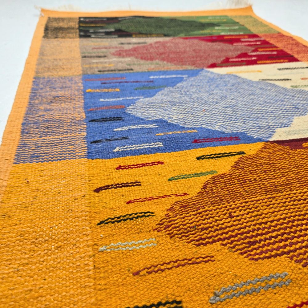 Bohemian Moroccan Azilal rug with bold geometric patterns in red, orange, purple, and multicolor wool, featuring abstract Berber tribal motifs and handwoven texture.