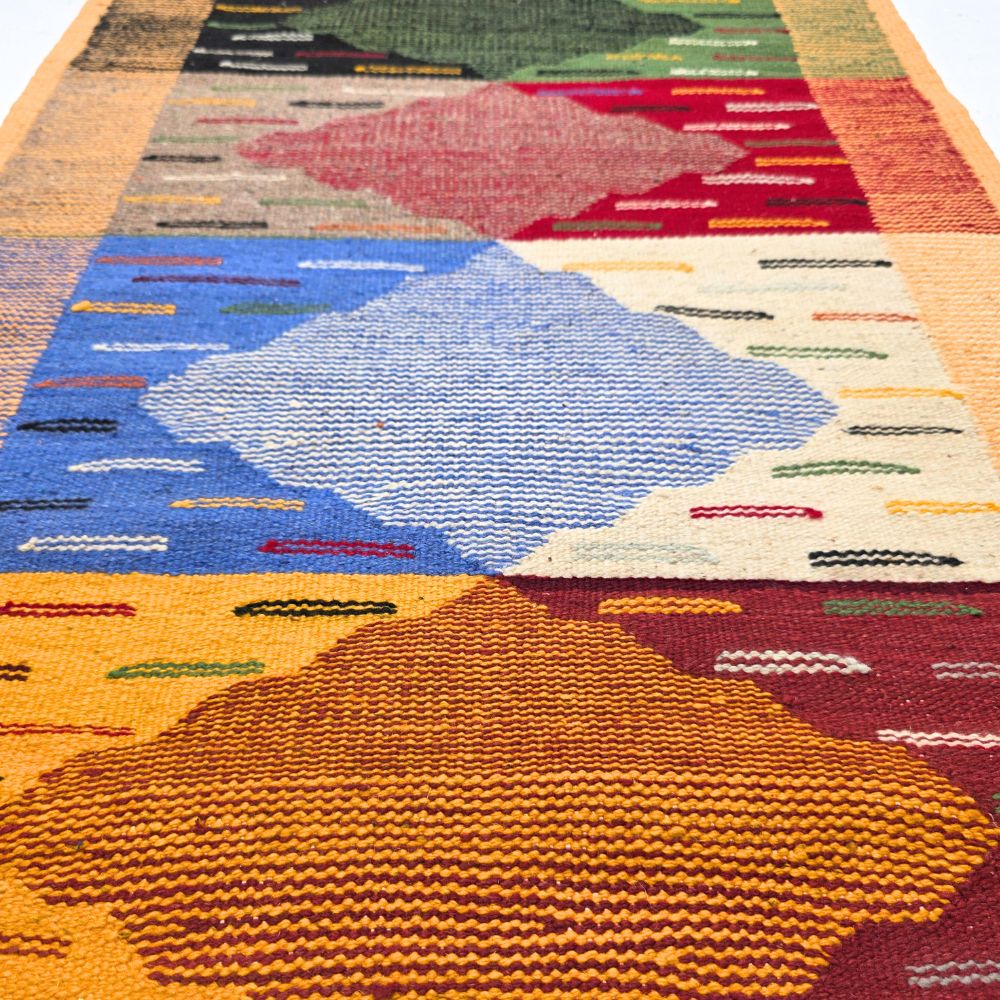 Bohemian Moroccan Azilal rug with bold geometric patterns in red, orange, purple, and multicolor wool, featuring abstract Berber tribal motifs and handwoven texture.