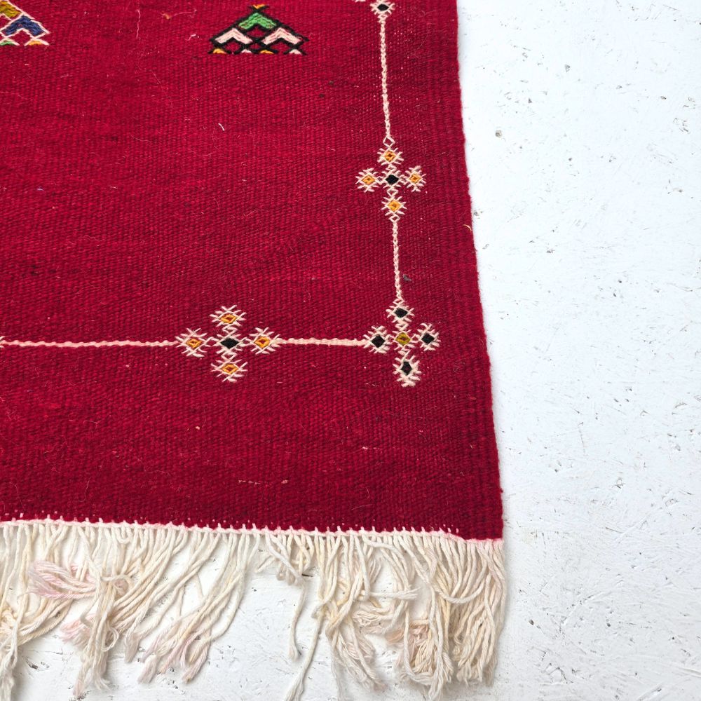 Bohemian Moroccan Azilal rug with bold geometric patterns in red, orange, purple, and multicolor wool, featuring abstract Berber tribal motifs and handwoven texture.