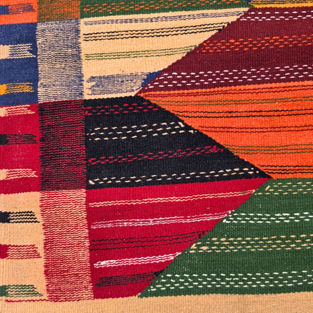 Bohemian Moroccan Azilal rug with bold geometric patterns in red, orange, purple, and multicolor wool, featuring abstract Berber tribal motifs and handwoven texture.