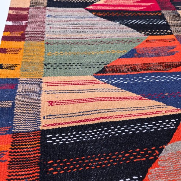 Bohemian Moroccan Azilal rug with bold geometric patterns in red, orange, purple, and multicolor wool, featuring abstract Berber tribal motifs and handwoven texture.