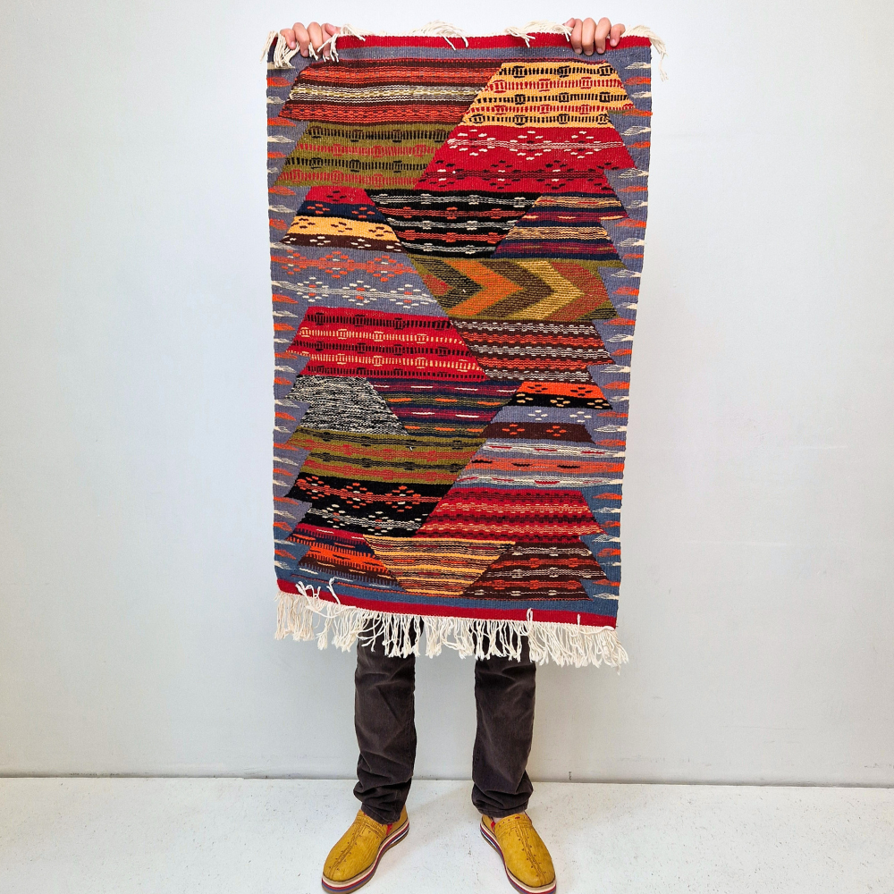 Bohemian Moroccan Azilal rug with bold geometric patterns in red, orange, purple, and multicolor wool, featuring abstract Berber tribal motifs and handwoven texture.