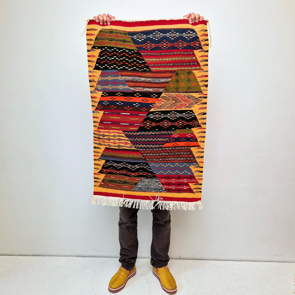 Bohemian Moroccan Azilal rug with bold geometric patterns in red, orange, purple, and multicolor wool, featuring abstract Berber tribal motifs and handwoven texture.