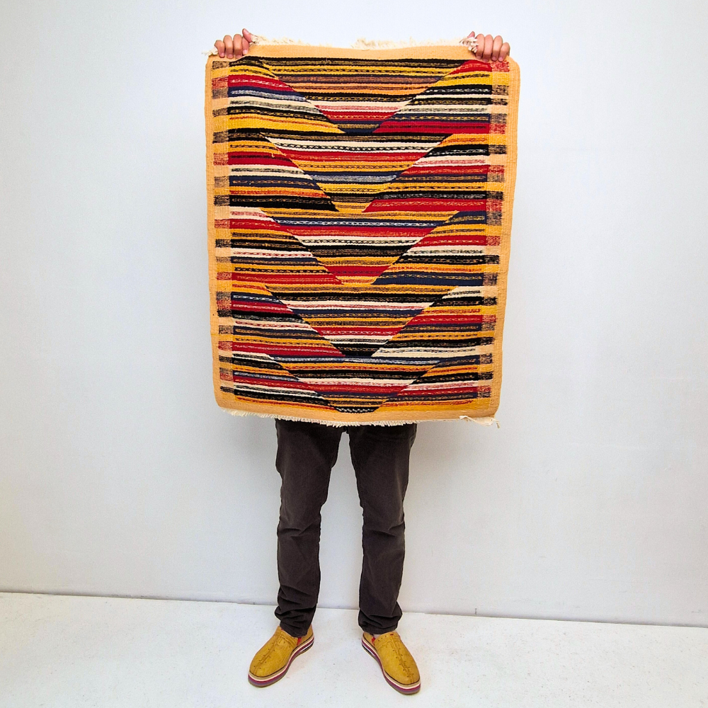 Bohemian Moroccan Azilal rug with bold geometric patterns in red, orange, purple, and multicolor wool, featuring abstract Berber tribal motifs and handwoven texture.