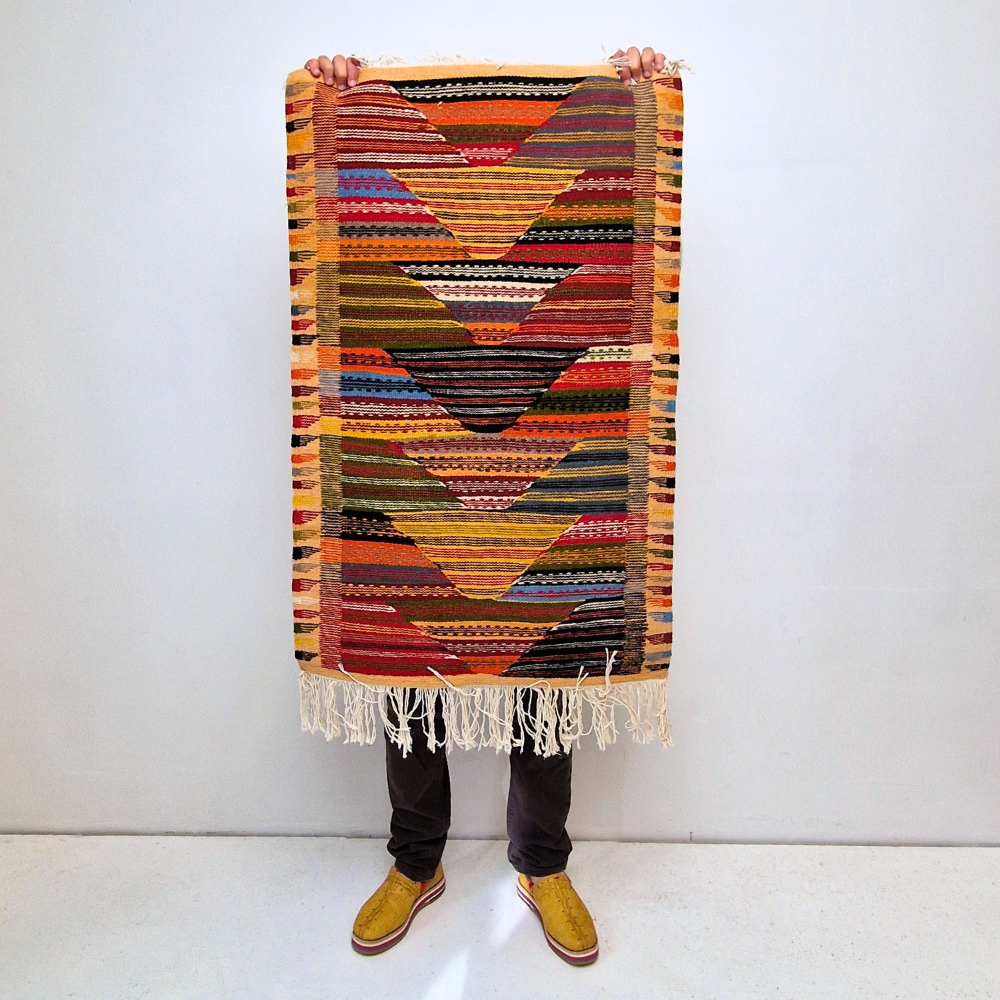 Bohemian Moroccan Azilal rug with bold geometric patterns in red, orange, purple, and multicolor wool, featuring abstract Berber tribal motifs and handwoven texture.