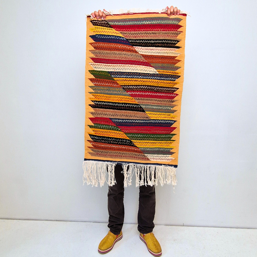 Bohemian Moroccan Azilal rug with bold geometric patterns in red, orange, purple, and multicolor wool, featuring abstract Berber tribal motifs and handwoven texture.