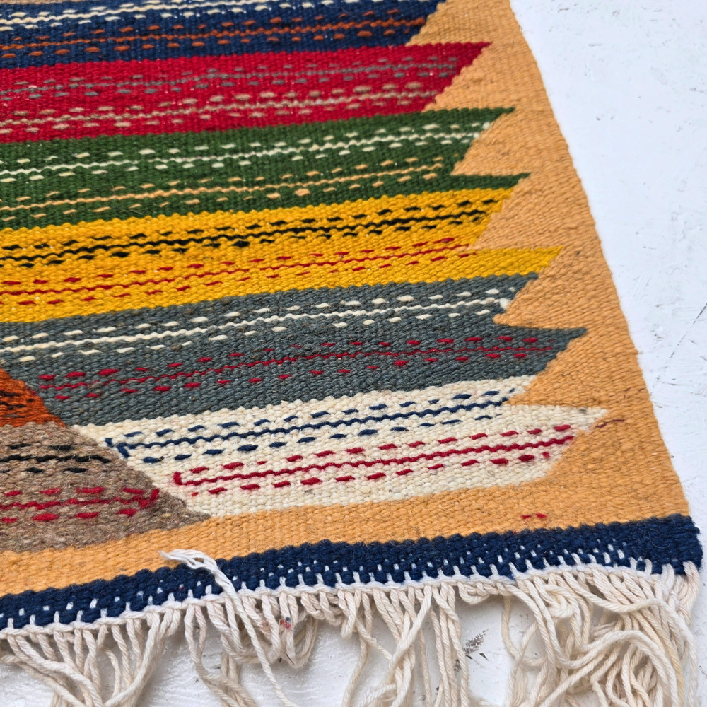 Bohemian Moroccan Azilal rug with bold geometric patterns in red, orange, purple, and multicolor wool, featuring abstract Berber tribal motifs and handwoven texture.