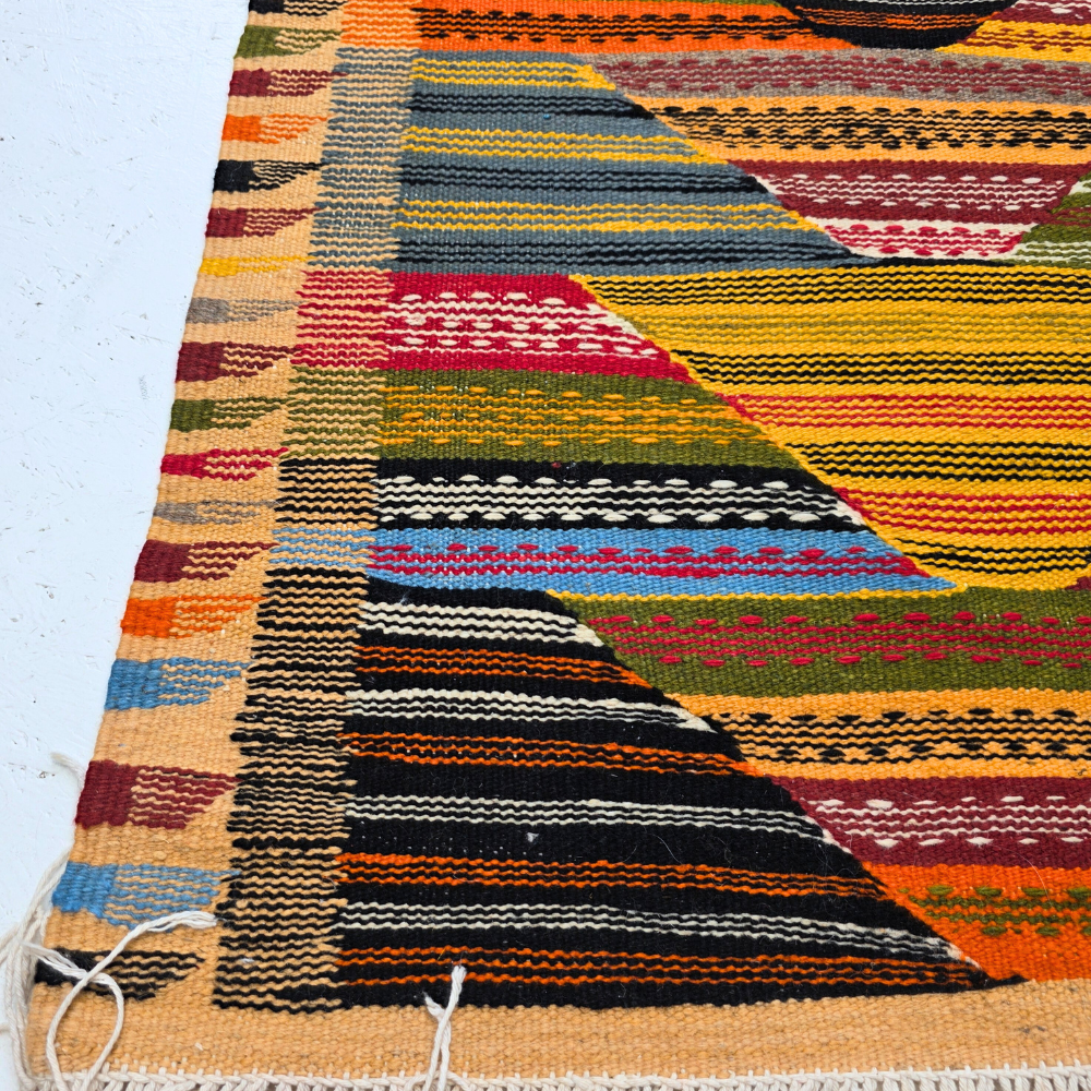 Bohemian Moroccan Azilal rug with bold geometric patterns in red, orange, purple, and multicolor wool, featuring abstract Berber tribal motifs and handwoven texture.