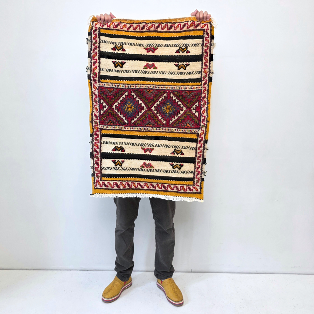 Bohemian Taznakht Diamonds Small Rug with bold geometric patterns in red, blue, white and multicolor wool, featuring abstract Berber tribal motifs and handwoven texture.