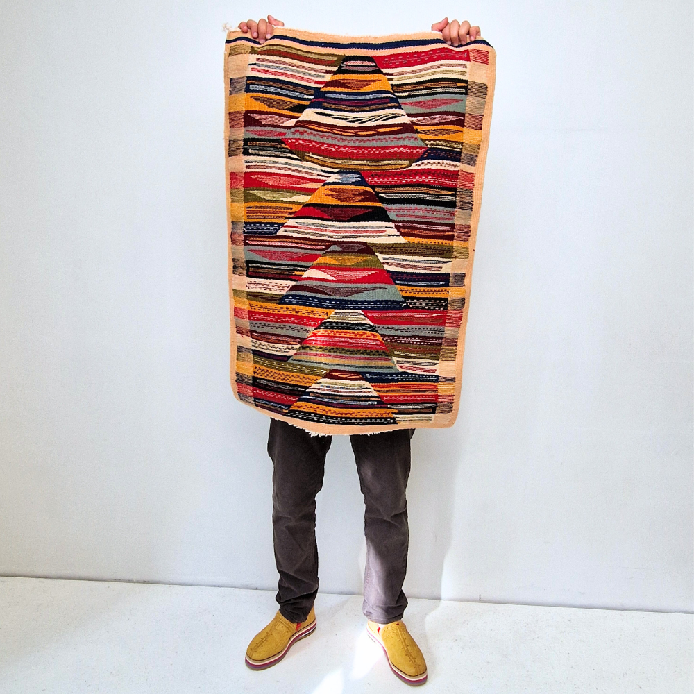 Bohemian Moroccan Azilal rug with bold geometric patterns in red, blue, white and multicolor wool, featuring abstract Berber tribal motifs and handwoven texture.