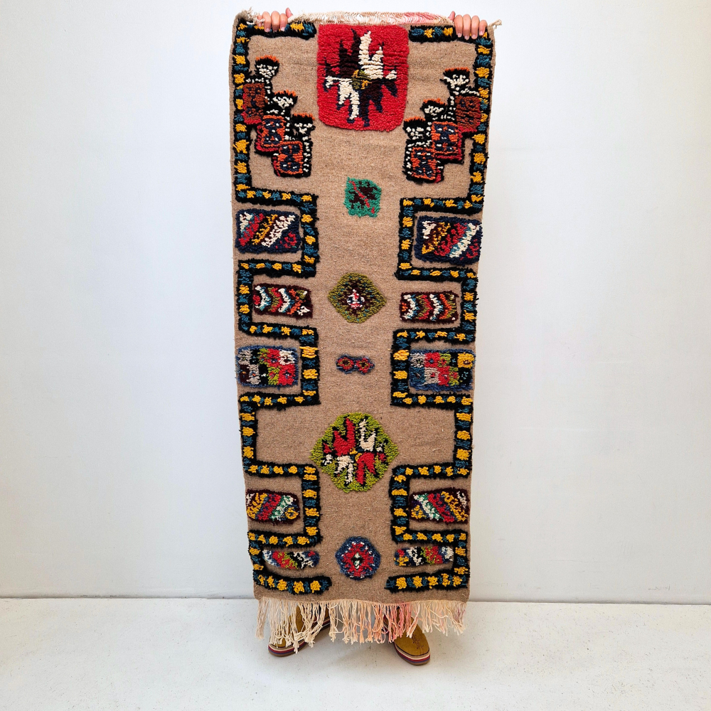 Bohemian Moroccan Azilal rug with bold geometric patterns in red, blue, white and multicolor wool, featuring abstract Berber tribal motifs and handwoven texture.