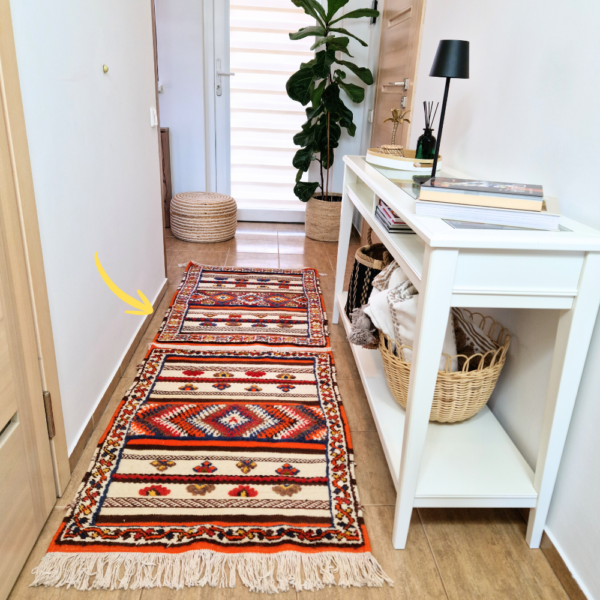 Bohemian Moroccan Azilal rug with bold geometric patterns in red, blue, white and multicolor wool, featuring abstract Berber tribal motifs and handwoven texture.