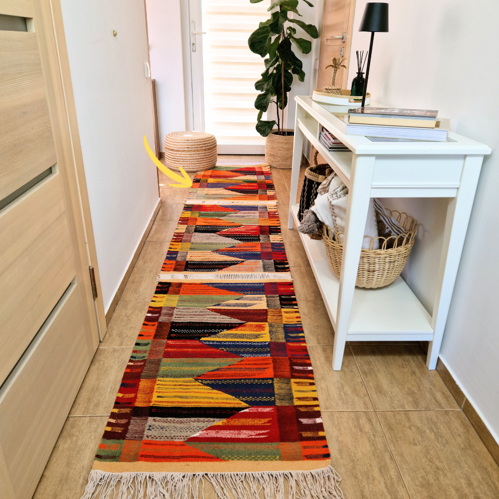 Bohemian Moroccan Azilal rug with bold geometric patterns in red, blue, white and multicolor wool, featuring abstract Berber tribal motifs and handwoven texture.