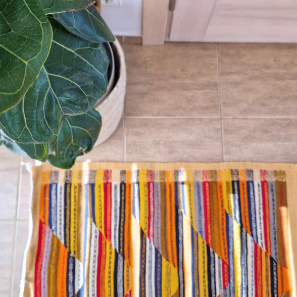 Bohemian Moroccan Azilal rug with bold geometric patterns in red, blue, white and multicolor wool, featuring abstract Berber tribal motifs and handwoven texture.