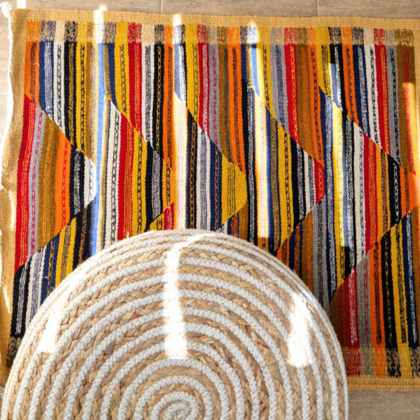 Bohemian Moroccan Azilal rug with bold geometric patterns in red, blue, white and multicolor wool, featuring abstract Berber tribal motifs and handwoven texture.
