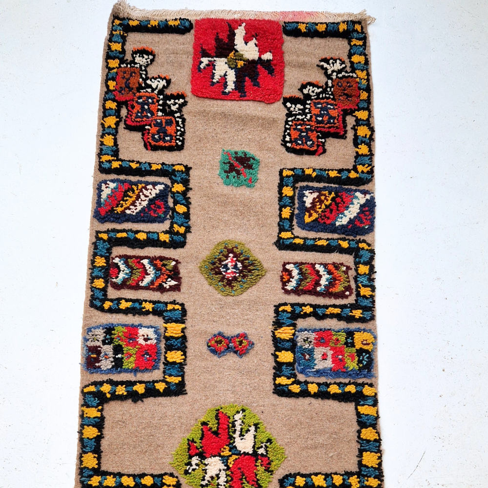 Bohemian Moroccan Azilal rug with bold geometric patterns in red, blue, white and multicolor wool, featuring abstract Berber tribal motifs and handwoven texture.