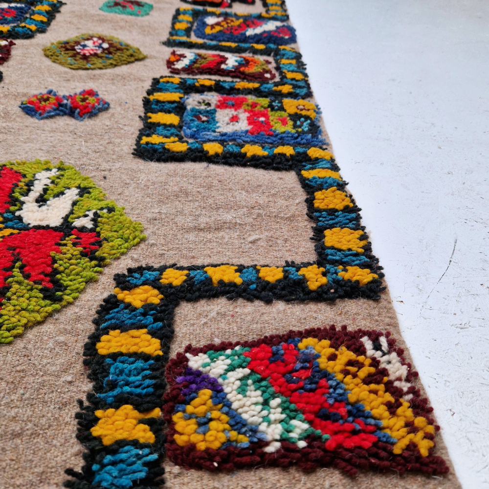 Bohemian Moroccan Azilal rug with bold geometric patterns in red, blue, white and multicolor wool, featuring abstract Berber tribal motifs and handwoven texture.