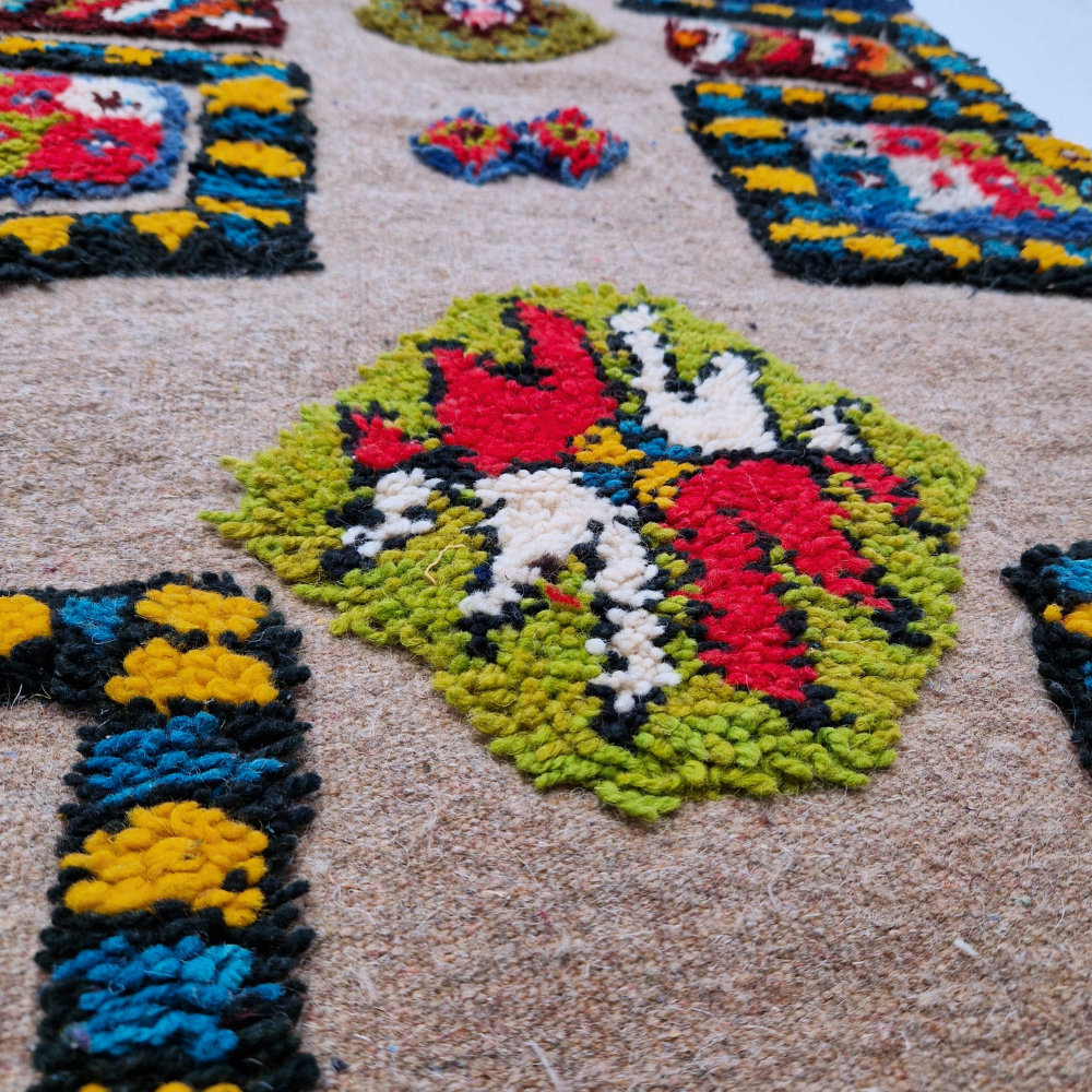 Bohemian Moroccan Azilal rug with bold geometric patterns in red, blue, white and multicolor wool, featuring abstract Berber tribal motifs and handwoven texture.