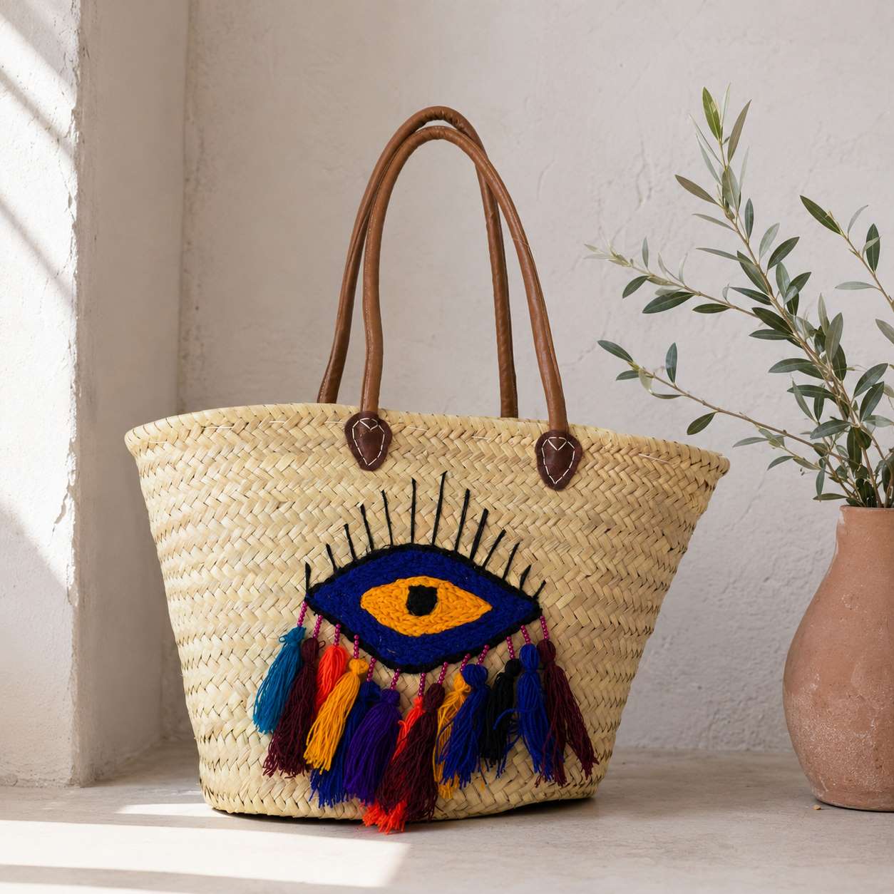 Handmade Moroccan Basket from Straws with an eye design ebroidred in it.
