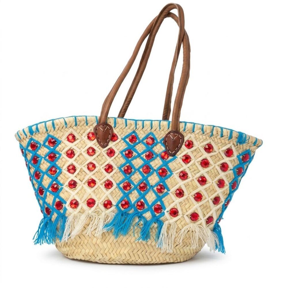 Handmade Moroccan basket bag woven from natural palm straw with leather handles, crystal gems, and a cinch-close inner lining. A unique artisan piece