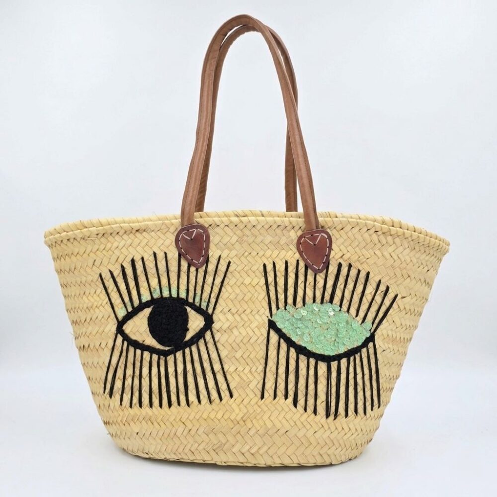 Moroccan winking eye basket bag with black lash embroidery, mint green sequin lid, and leather handles
