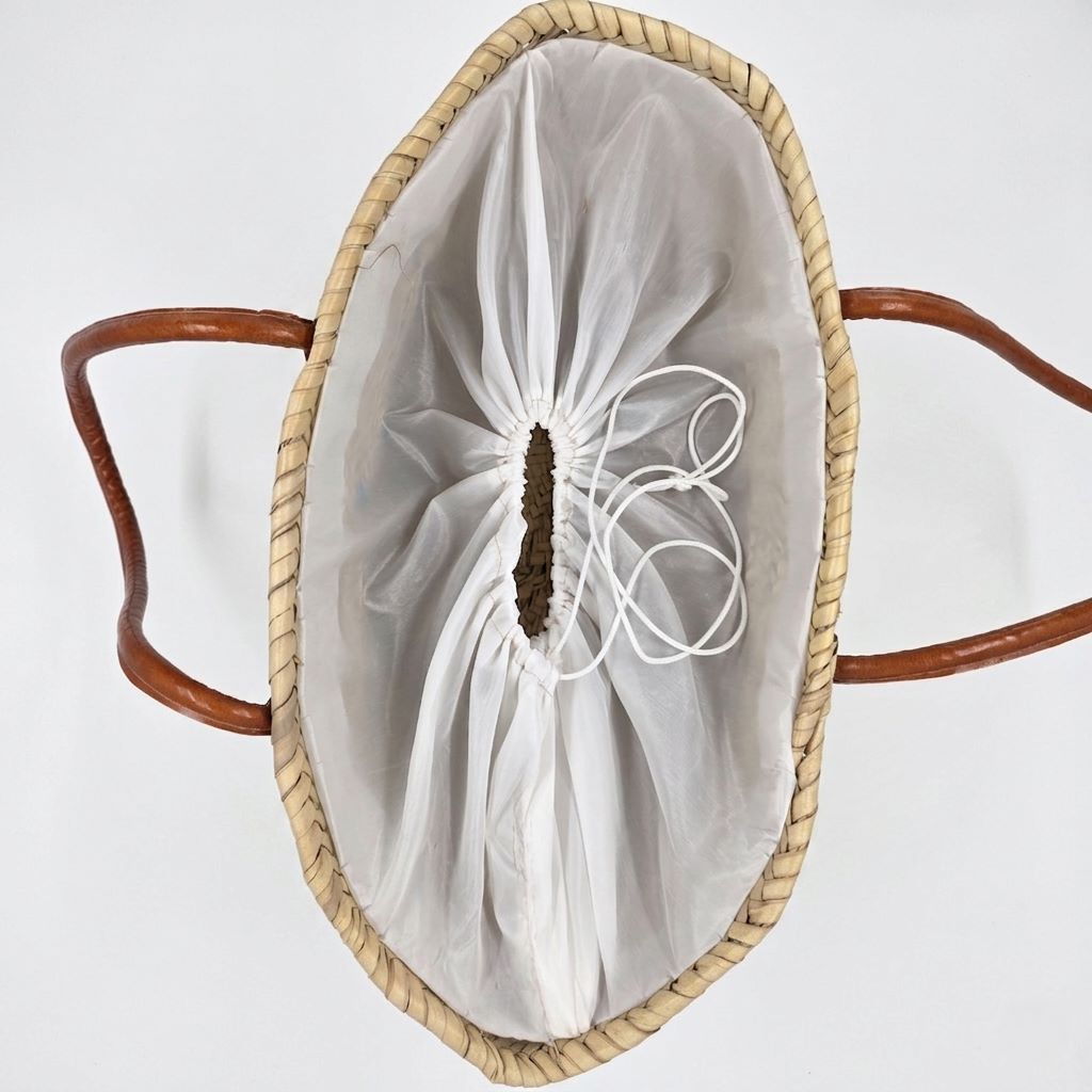 Beach quote basket bag with "Madame à la Plage" hand-stitched in teal thread and leather handles